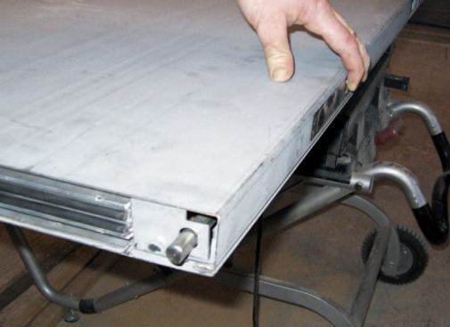 The bolts engage when the active door closes and depresses the lever mechanism, then retract when the active door is opened again.