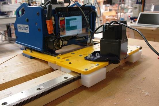 The yellow plate and outboard motor attached to the Handibot constitute the “crawler” device which moves the unit along a toothed steel track. The track is available in lengths up to 20 feet which makes the tool capable of precision cutting on some pretty big work pieces.