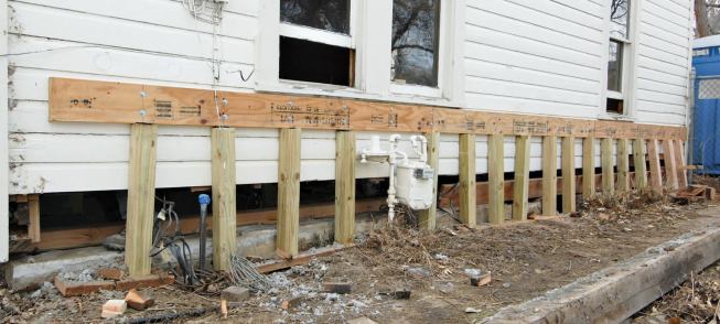 LVL ledgers attached to the exterior wall studs with structural screws provided a means of support as the sill was removed and the steel beam maneuvered into place.