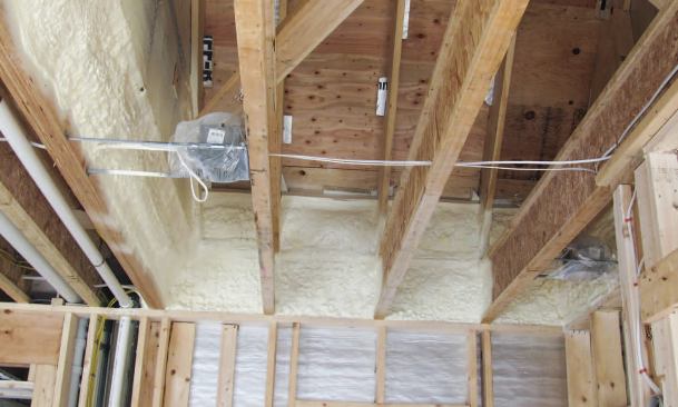 A 3-inch layer of spray foam effectively air-seals the vent baffles against the framing and insulates the rim joists to about R-18.