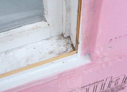 The long horizontal tongue-and-groove joints in the rigid foam were left unglued to provide for thermal expansion, but all the joints were taped, and the foam was also taped to the flashings.