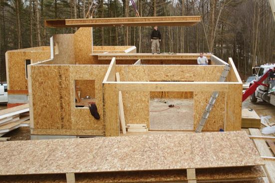 Just like the first-story SIP floors, the preassembled I-joist floor sections are flown into place with the crane.