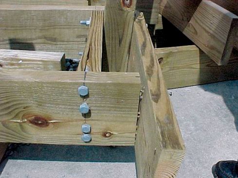 After testing the bolted and lagged connections, the authors tried reinforcing the post with blocking in a variety of configurations. Each configuration they tried failed when the blocking split along the grain.