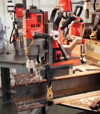 M18 Fuel Magnetic Drill (
2787) is not the first tool of its kind (Metabo offers a 25.2-volt model) but it is the first to be powered but the same 18-volt packs used in common tools such as drill/drivers and impact wrenches. This is not a tool you will see at the home center or on every jobsite, but it makes sense for metal fabricators, steel erectors, and maintenance repair and operations (MRO) folk who need to drill holes in steel in locations where electricity is not available or where the use of cords (or generators) would be a problem. According to its maker the drill can make up to 40 13/16” holes in 1/4-inch steel per charge (w 5.0 Ah pack). The base contains permanent magnets that provide 2,000 pounds of holding force and won’t let go when the battery is depleted or removed from the tool. Features include a 2-speed gearbox, 3/4” Weldon quick-change chuck (includes adapter to 1/2” 3-jaw chuck), and Auto-Stop lift off protection to shut the tool down if the base starts to move. Capacity: up to 1 1/2” annular cutter or 1/2” twist bit. Speed: 460/690 rpm. Stroke: 5 3/4”. Weight: 29.5 pounds with battery. A slightly different version of the tool (2788) will be available for use by electrical linemen (with lifting loop and other additional features). COO: China. Available: July 2015.