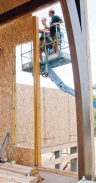 To prevent wind deflection, the tall window walls were reinforced with full-length flitch beam stiffeners.