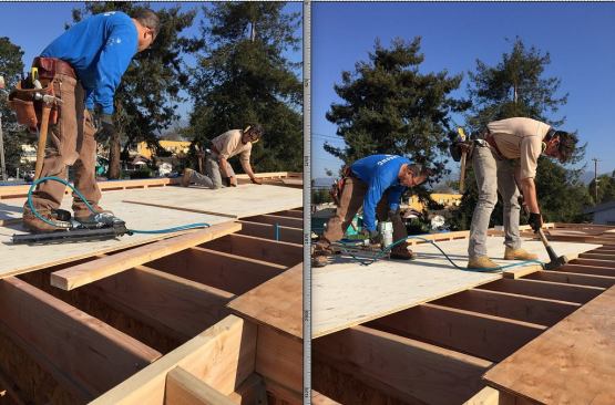 Gregor and lead carpenter Margarito sheathe the new low-slope roof.