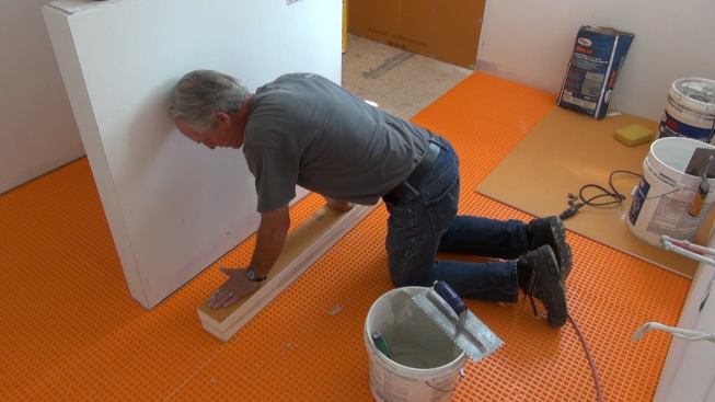 Boucher presses the two Kerdi-Board pieces together to create a good mortar bond at the lamination joint.