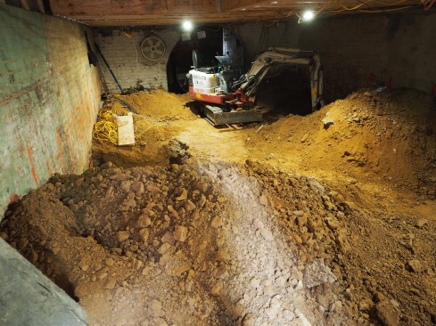 As work proceeds, the basement fills up with dirt.