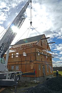We had allowed ¼-inch clearance on either side of the wall framing for wiggle room. With two tag lines, we placed the roof with little effort.