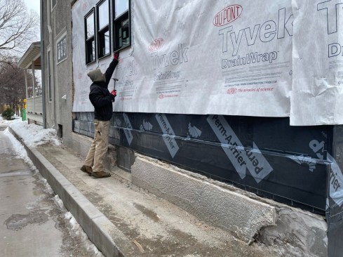 It's a wrap: The O-A Design-Build dries in the new wall before installing new windows.
