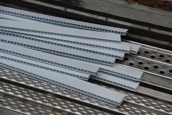 Strips of corrugated drainable plastic strapping ready for use.