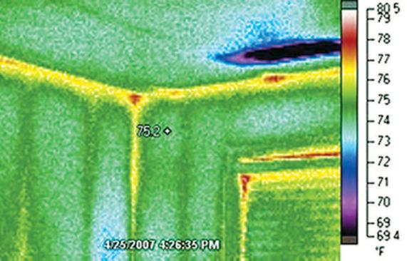 In this air-conditioned structure, the prominent cool area on the ceiling lies directly in the path of a supply duct.