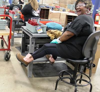 This gal cleans and inspects tools before they are sent out for packaging. In response to a question from one of the folks on the tour she’s showing off her Texas-style steel-toe work boots.