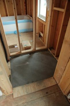 The Hydro Ban linear drain body is simply positioned in the mortar bed, which must be sloped 1/4 inch per foot toward the drain.