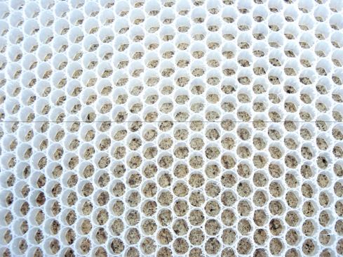 QuickDrain USA's flat panels and sloping panels are made out of an innovative honeycomb material and bond to plywood or concrete subflooring (and to each other) with thinset mortar, which also fills the individual honeycomb cells for increased compressive strength.