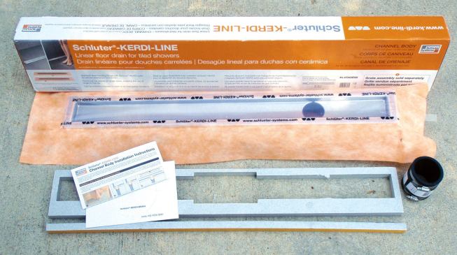 Manufactured by Schluter, the Kerdi-Line system’s drain body (called the channel body) is sold separately from the grate assembly. Drains are available in lengths from 20 inches to 72 inches with either center or off-center drain outlets that connect to the waste line by a hubless connector.