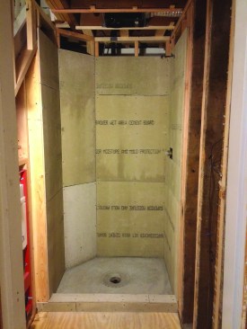 To maximize the size of the shower, tile backerboard was attached directly to the wall framing. The angled corner gave the kitchen island a little more clearance on the other side of the wall.