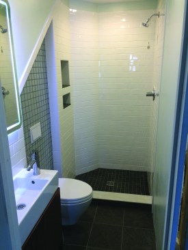 With careful planning and space-saving fixtures, along with some creative framing and inventive plumbing, the unused hallway was converted into a functional bath with a shower.