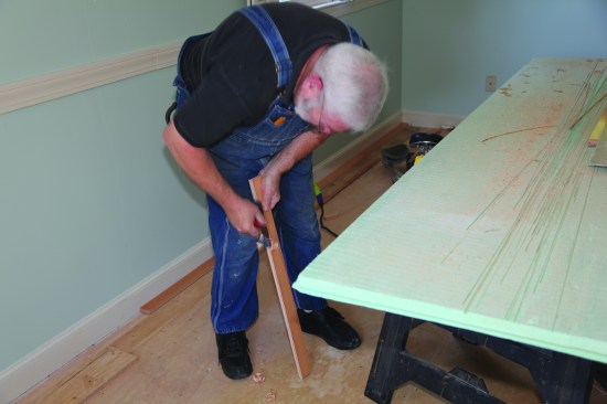 The quickest and most accurate way to cut to the scribe line is with a hand plane. The angled cut from the saw makes this a quick operation.