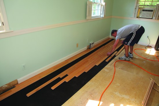 While one of the crew nails off the first courses, another "racks" the boards to be installed. Boards are placed on the floor with seams staggered the proper amount. The installer can then just pull the boards over with his feet and nail them into place.