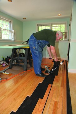 The quickest way to install the flooring is to pull the pieces over and install them in a stair-step fashion. Usually one of the crew cuts the end pieces while the other continues installing the "steps."