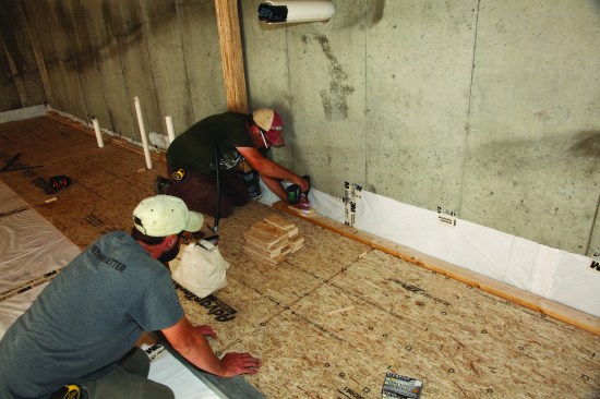 Because the subsequent courses had to be driven together to engage the tongue-and-groove edges, solid backing was created by putting a
2x4 against the back of the first course and then screwing down scrap blocks that rested against the foundation.