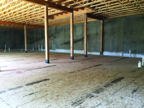 This layer was screwed to the first with 1 1/4-inch screws that would not
penetrate to the poly sheet below. Screws went in every 6 inches at the edges and every 12 inches in the field. When both layers were finished, the poly was secured to the wall with two rows of waterproof tape.Photo by Steve Demetrick