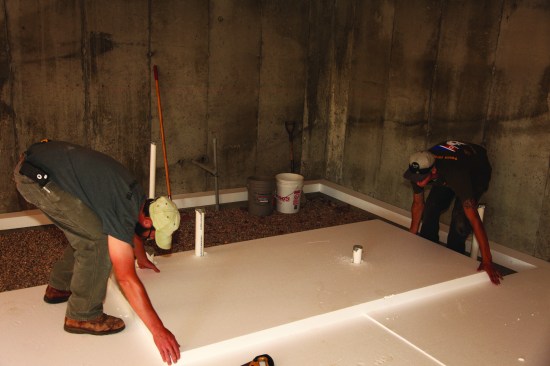 To fit the sheets of insulation around the numerous plumbing pipes and support columns, their locations were plotted on the sheets and corresponding holes were cut out.