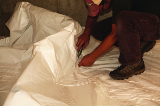 The sheets were carefully smoothed out and cut for each plumbing pipe.