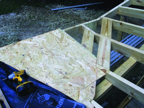 Sheathing blocking is added along the valley, and the sheathing pieced in for both roof planes.