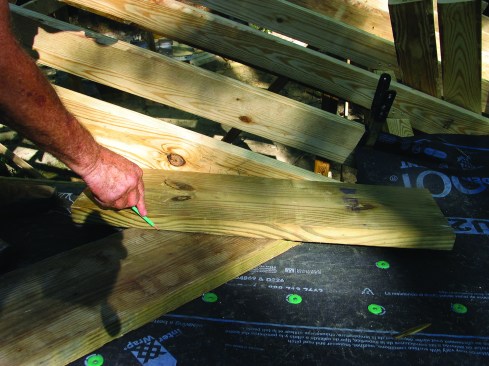 After the blind valley pieces are located, the ends are angled by scribing along a 2-by against the common rafter