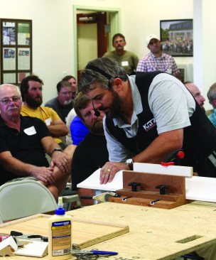 Scott Wells explains to the audience how to cope crown molding with a jigsaw.