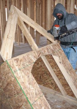 Rafters: The rafters are installed flush with the gable end and their plumb cuts flush with the outside edges of the sidewalls.
