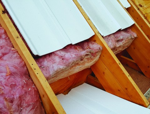 Existing fiberglass batts in the rafter bays were exposed to wind-washing at the eaves.