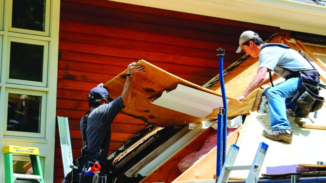 Working from outside, the crew removed the existing sheathing.