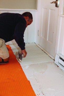 The second pass with a 3/8-inch-by-3/8-inch square-notched trowel combed the thinset perpendicular to the long edge of the tile.