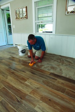 When the haze dried, he went over the tile again with a clean, damp sponge, this time moving only in a direction parallel to the tile planks. He made only a single pass with each side of the sponge before rinsing it in clean water. Two days later, he returned and cleaned the floor with a stone and tile cleaner.