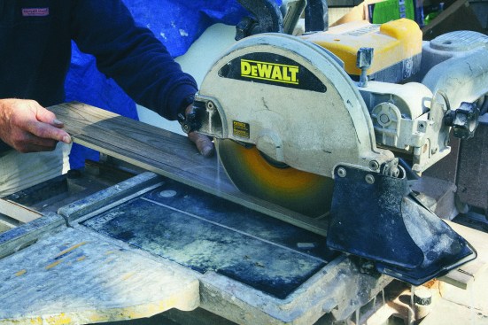 Next, he carefully cut the strip lengthwise in a tile saw.