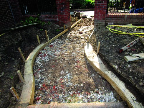 He cut out the templates and used them to position the forms for the slab under the walkway.