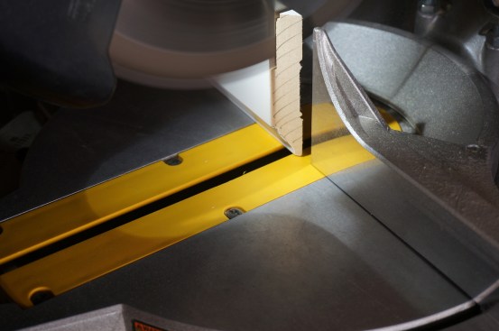 With the back bevel angle set, the author cuts downward letting the cut follow the edge of the vertical profile.