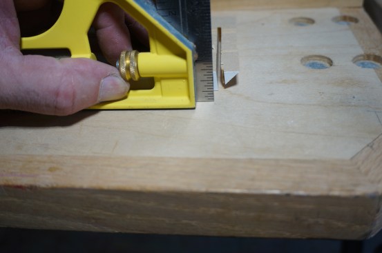 A square held next to the vertical cut clearly shows back bevel angle.