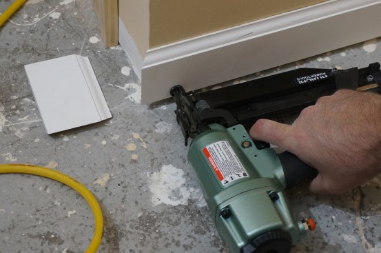 Installation follows the same order as measuring and cutting. The first pieces made up an outside corner, so the author fit them together to make sure the joint was tight and then secured the piece at the stud position closest to the corner.