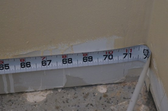 A tape measure will not extend neatly into a  corner to take a measurement. Instead you must learn to read the measurement where the tape wraps through the corner. In this case the measurement is 71 7/8 inches.