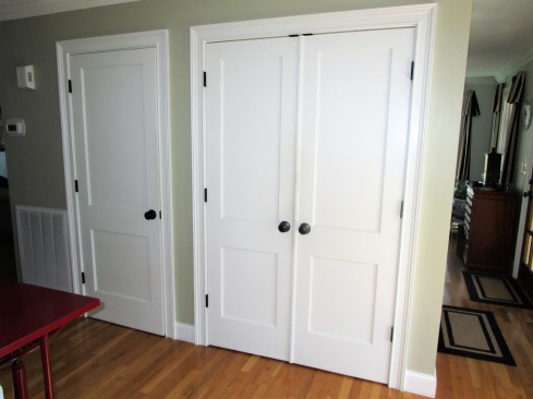 The pantry space in this home was originally accessed by three swing-out doors. When open, these doors blocked foot traffic in this busy hallway.