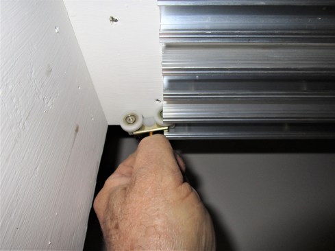 Gaps between the ends of the overhead tracks and the side jamb allows the rollers to slide into place. 