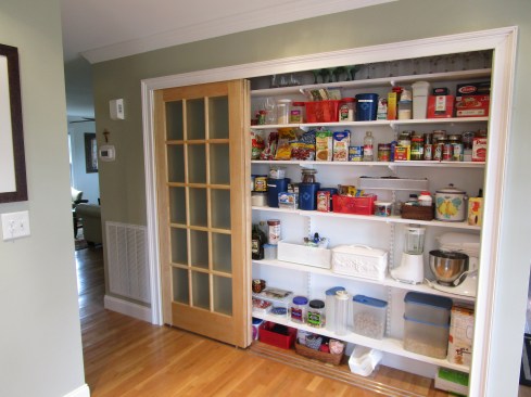 The three door panels move independently so they can all open to one side if need be. The head casing for the opening extends down past the top of the door to conceal the tracks and the hardware.