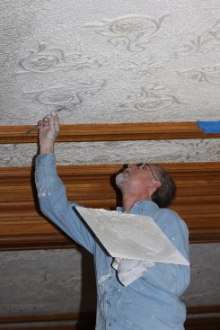 Ron Bisson uses a rodding spatula to help texture the ceiling.