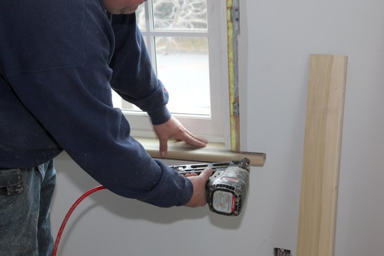A single nail through the horn of the stool and into the RO framing draws the horn in tight against the drywall.