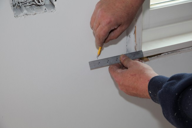 To determine the length of the stool, measure out the width of the reveal at the jamb, plus the width of the casing, plus the width of the overhang. Mark that distance on the wall on both sides of the window and measure between your marks for the overall length of the stool.