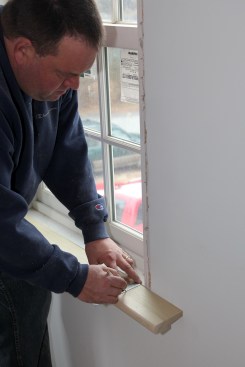 Hold the ruler against the back edge of the stool and mark the distance you just measured on the line for the jamb. If the wall is noticably askew to the back of the stock, measure off the drywall near the jamb instead.